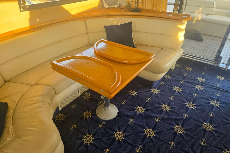 Slide: The Image of Luxurious Sunseeker Manhattan 48 yacht interior with elegant seating and nautical-themed carpet. - 58