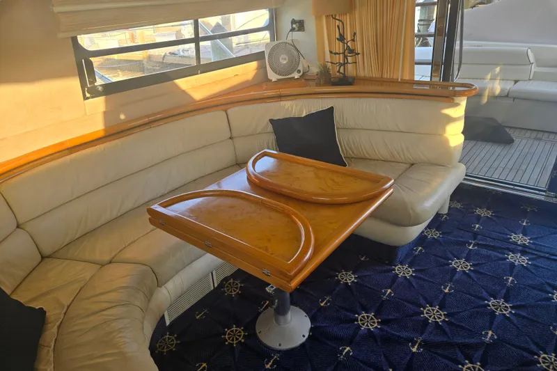 Slide: The Image of Luxurious interior of 1997 Sunseeker Manhattan 48 yacht with elegant seating and wooden table. - 59