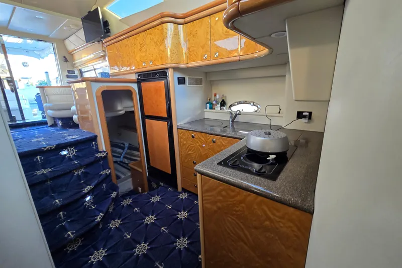 Slide: The Image of Luxurious interior of 1997 Sunseeker Manhattan 48 yacht with modern kitchen and elegant design. - 62