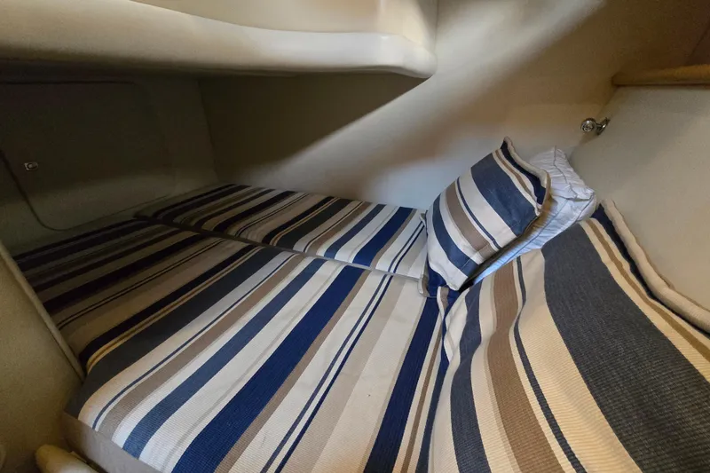 Slide: The Image of Cozy cabin bed with striped bedding in 1997 Sunseeker Manhattan 48 yacht. - 63