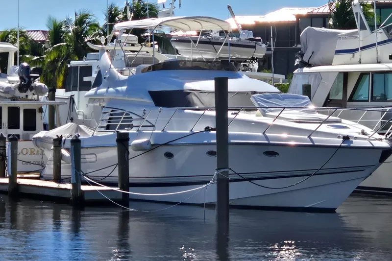 Slide: The Image of 1997 Sunseeker Manhattan 48 yacht docked at marina, surrounded by other boats. - 7