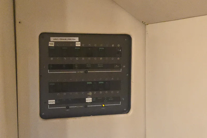 Slide: The Image of Electrical panel inside 1997 Sunseeker Manhattan 48 yacht, featuring labeled switches and controls. - 72