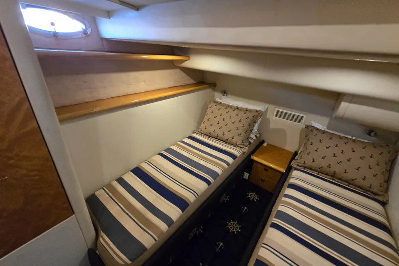 Slide: The Image of Twin cabin interior of 1997 Sunseeker Manhattan 48 yacht with striped bedding and nautical decor. - 74