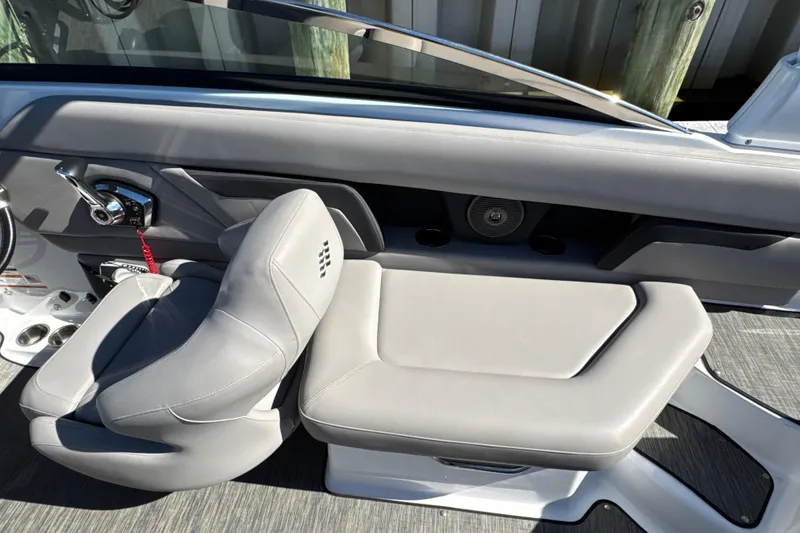 Slide: The Image of 2023 Four Winns HD5 OB boat interior with gray seating and control panel. - 13