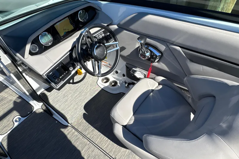 Slide: The Image of 2023 Four Winns HD5 OB boat cockpit with modern steering and controls. - 14