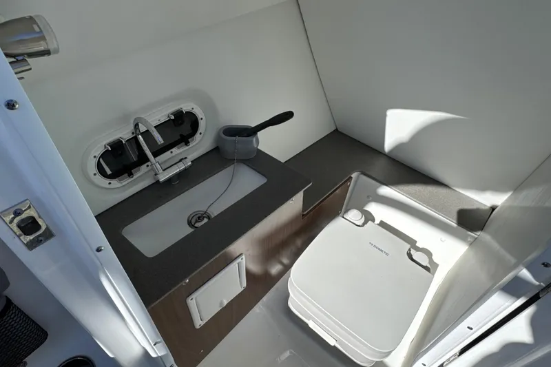 Slide: The Image of 2023 Four Winns HD5 OB boat interior with sink and portable toilet. - 19