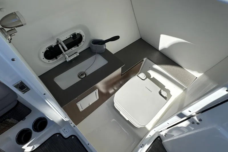 Slide: The Image of 2023 Four Winns HD5 OB boat interior with sink and portable toilet. - 20