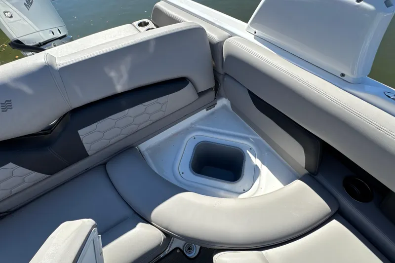 Slide: The Image of 2023 Four Winns HD5 OB boat interior with cushioned seating and storage compartment. - 30