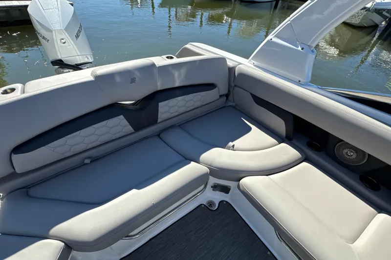 Slide: The Image of 2023 Four Winns HD5 OB boat interior with gray seating and water view. - 32
