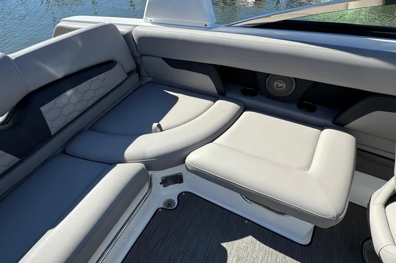 Slide: The Image of 2023 Four Winns HD5 OB boat interior with gray seating and speaker. - 6