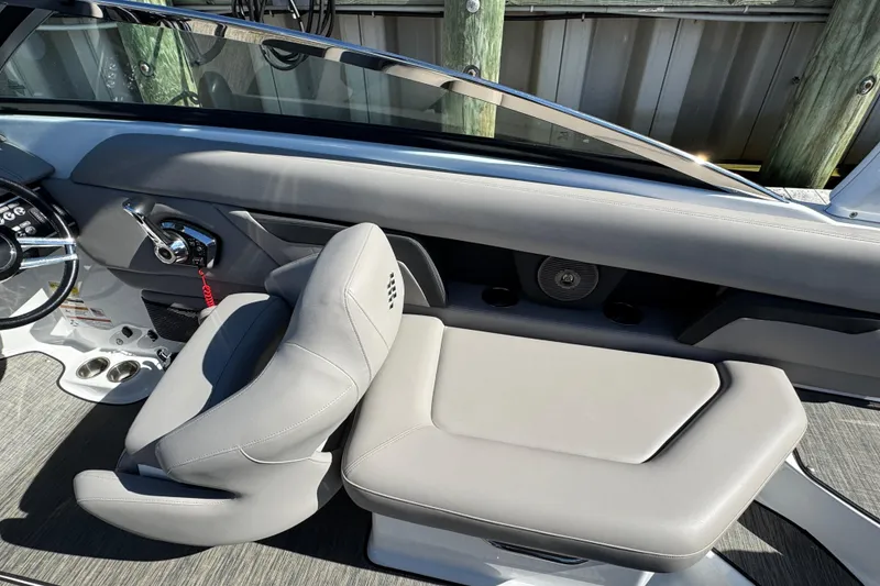 Slide: The Image of 2023 Four Winns HD5 OB boat interior with gray seating and steering wheel. - 8