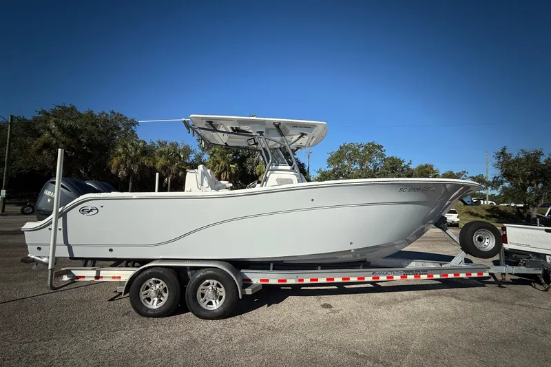 The Image of 2022 Sea Fox 288 Commander boat on trailer, parked outdoors under clear blue sky. - 0