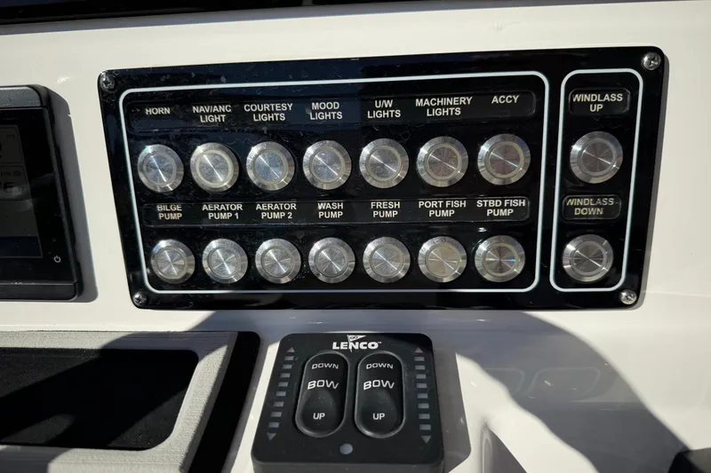 Slide: The Image of Control panel of a 2022 Sea Fox 288 Commander boat with labeled switches and buttons. - 17
