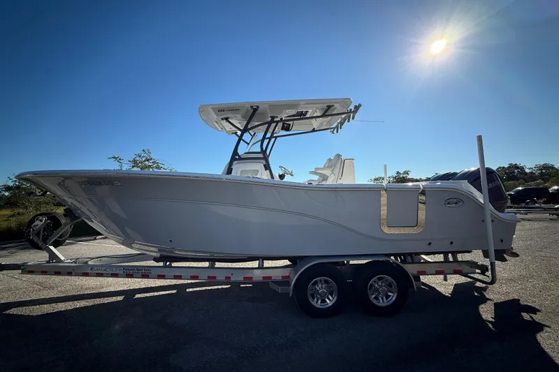 Slide: The Image of 2022 Sea Fox 288 Commander boat on trailer under bright sun. - 2