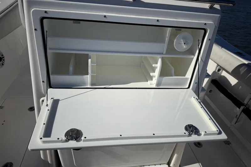 Slide: The Image of 2022 Sea Fox 288 Commander boat storage compartment with open lid and organized shelves. - 33