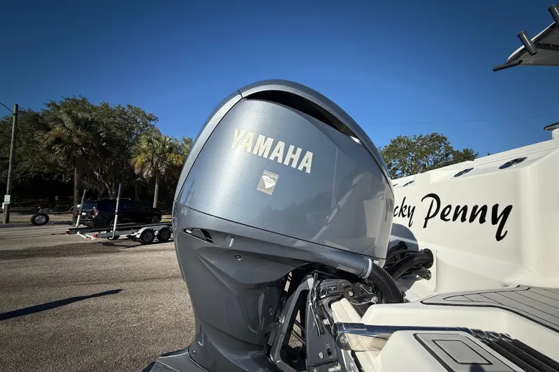 Slide: The Image of 2022 Sea Fox 288 Commander with Yamaha outboard motor, parked on a sunny day. - 4
