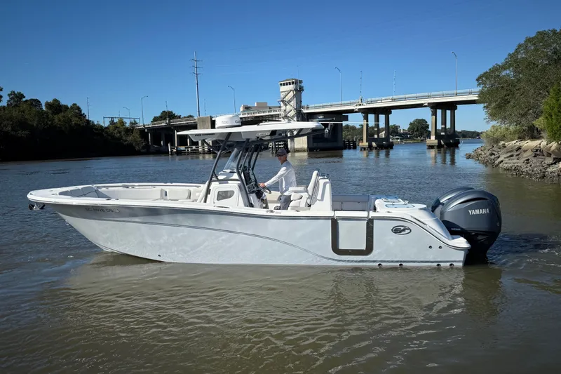 Slide: The Image of 2022 Sea Fox 288 Commander boat on a river near a bridge, featuring Yamaha engine. - 6