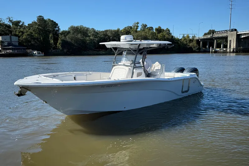 Slide: The Image of 2022 Sea Fox 288 Commander boat on a calm river near a bridge. - 7