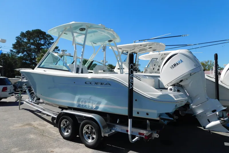 Slide: The Image of 2026 Cobia 240 Dual Console boat on trailer at dealership. - 1