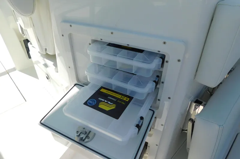 Slide: The Image of 2026 Cobia 240 Dual Console boat interior with open storage compartments. - 11