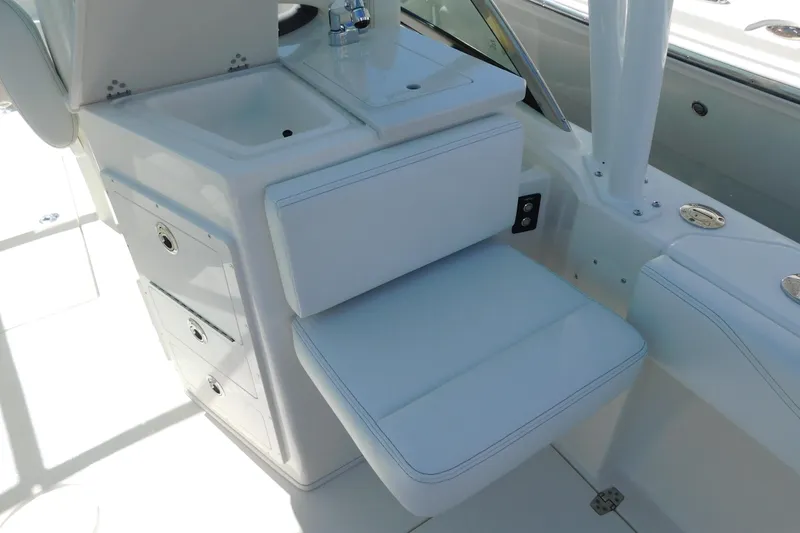 Slide: The Image of 2026 Cobia 240 Dual Console boat with organized tackle storage compartments. - 12