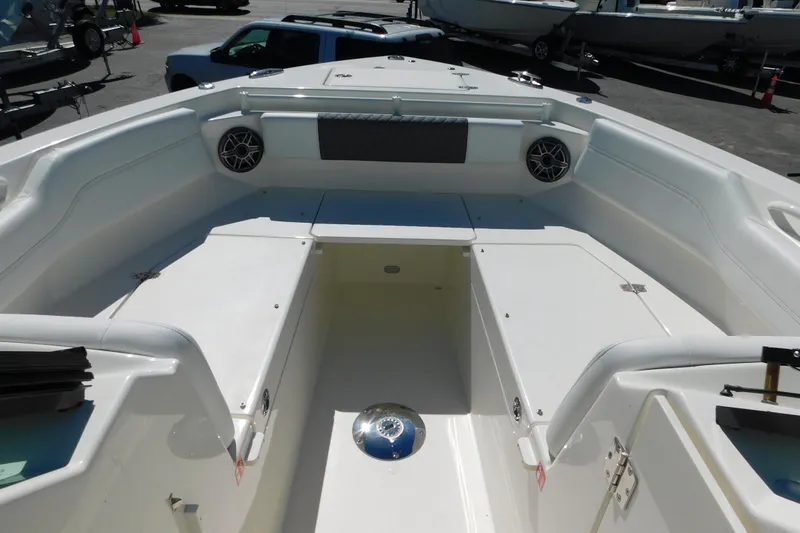 Slide: The Image of 2026 Cobia 240 Dual Console boat storage compartment with open hatch. - 18