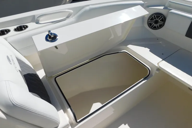 Slide: The Image of Open storage compartment on 2026 Cobia 240 Dual Console boat. - 21