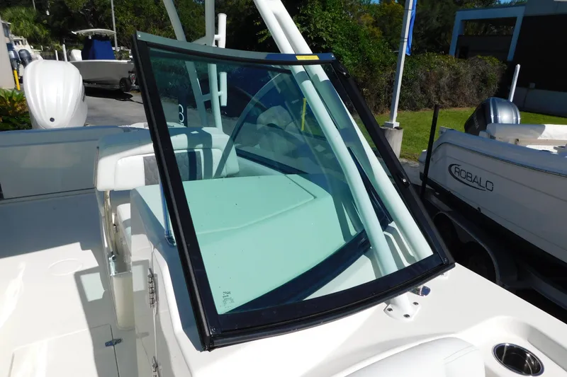 Slide: The Image of 2026 Cobia 240 Dual Console boat interior with cushioned seating and sleek design. - 24