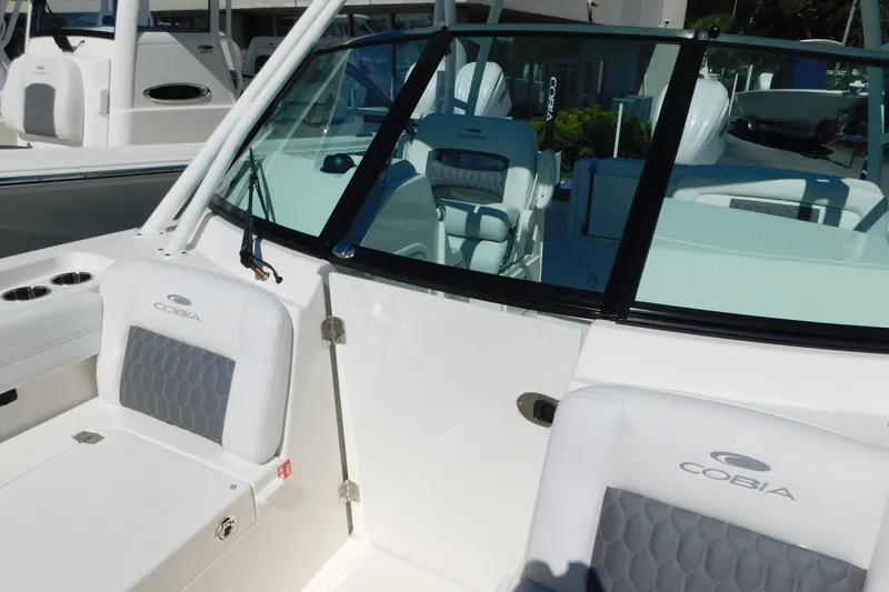 Slide: The Image of 2026 Cobia 240 Dual Console boat with sleek windshield design. - 25