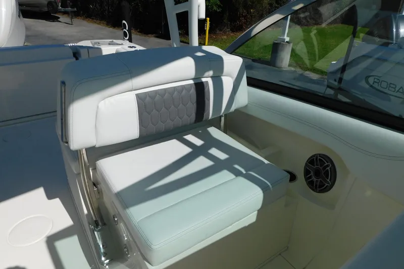 Slide: The Image of 2026 Cobia 240 Dual Console boat interior with luxurious seating and steering wheel. - 27