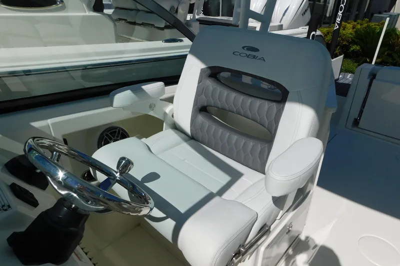 Slide: The Image of 2026 Cobia 240 Dual Console boat seat with modern design and speaker detail. - 28