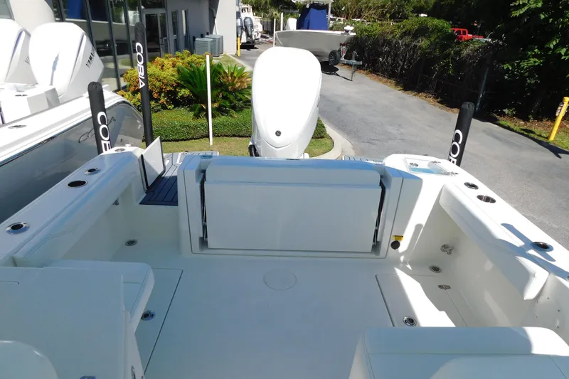 Slide: The Image of 2026 Cobia 240 Dual Console boat interior with steering wheel and cushioned seat. - 29