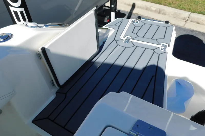 Slide: The Image of Control panel of 2026 Cobia 240 Dual Console boat with switches and dials. - 32