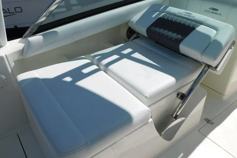 Slide: The Image of 2026 Cobia 240 Dual Console boat interior with open storage compartment. - 35