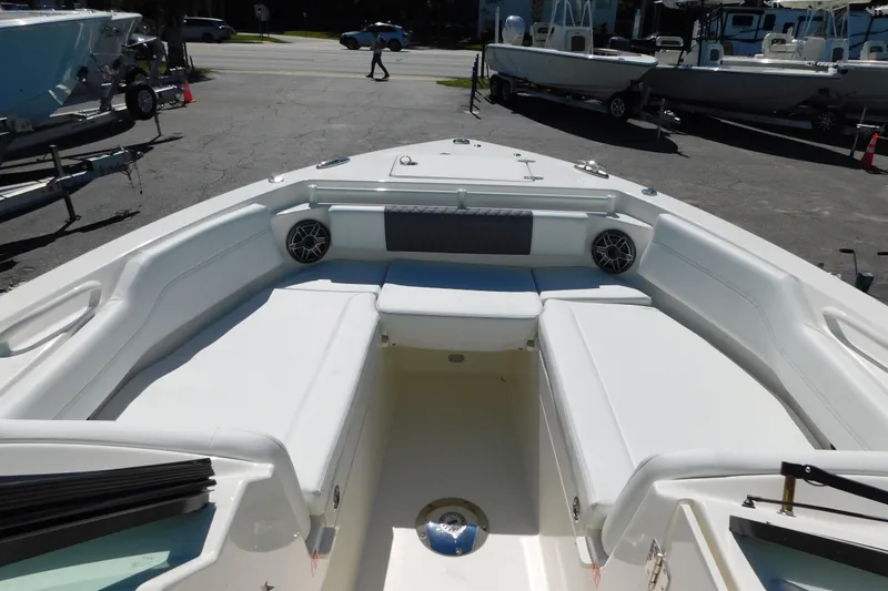Slide: The Image of 2026 Cobia 240 Dual Console boat interior with cushioned seating and speaker. - 38