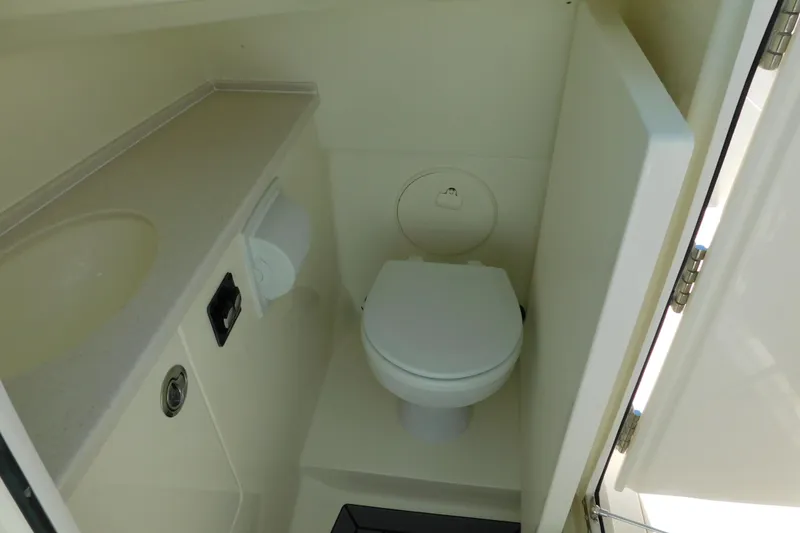 Slide: The Image of 2026 Cobia 240 Dual Console boat interior with sink and toilet. - 41