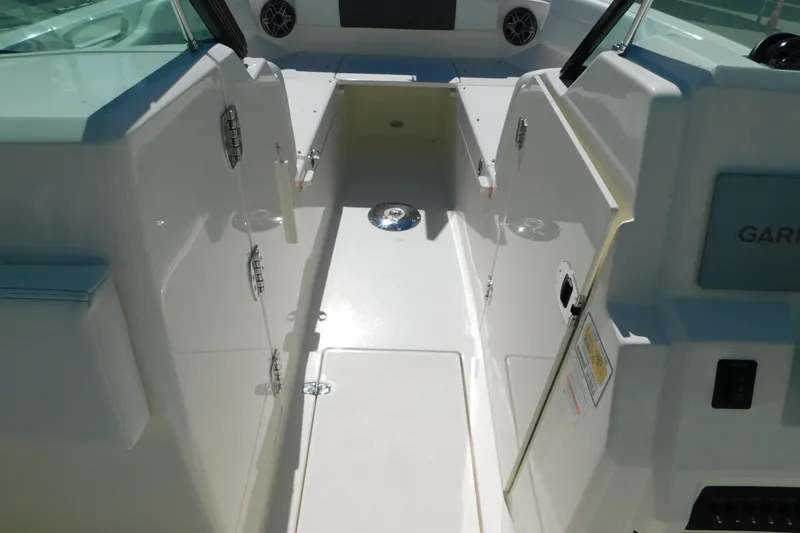 Slide: The Image of 2026 Cobia 240 Dual Console boat interior with seating and windshield. - 48