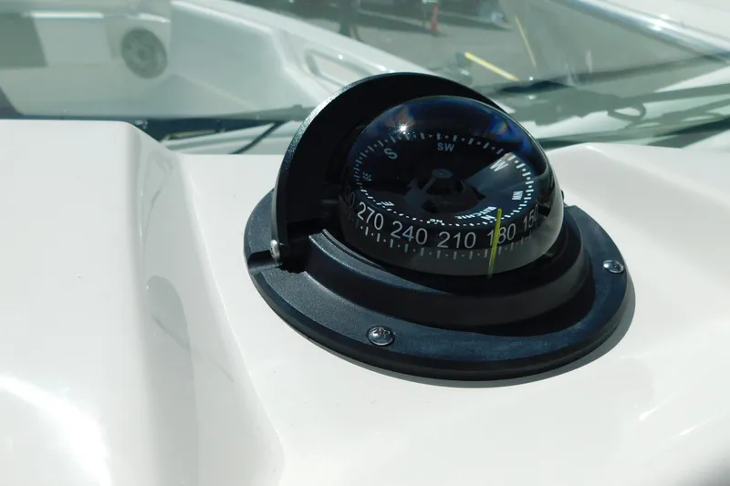 Slide: The Image of 2026 Cobia 240 Dual Console boat interior with storage compartments and seating area. - 49