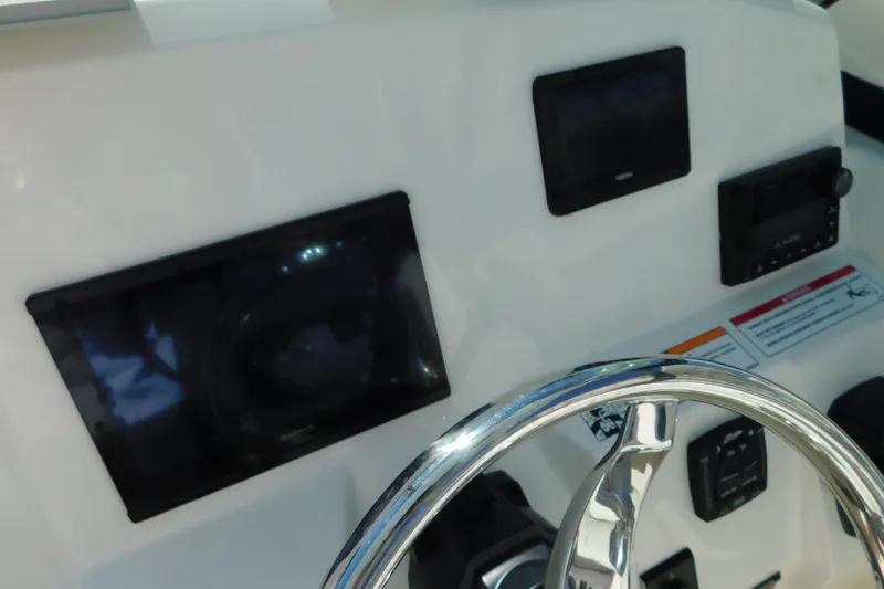 Slide: The Image of Compass on 2026 Cobia 240 Dual Console boat dashboard, close-up view. - 50