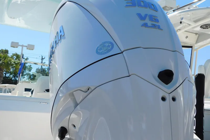 Slide: The Image of 2026 Cobia 240 Dual Console boat on trailer, showcasing engine mount and hull details. - 52