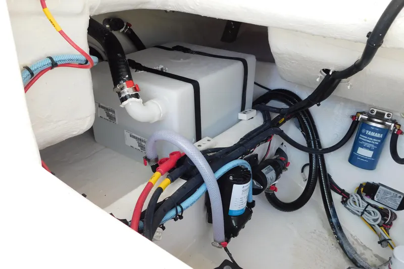 Slide: The Image of Engine compartment of 2026 Cobia 240 Dual Console boat, showcasing wiring and components. - 56