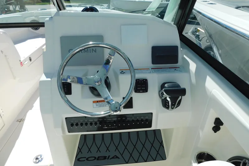 Slide: The Image of 2026 Cobia 240 Dual Console boat on trailer, side view. - 6