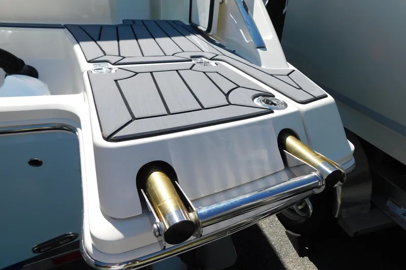 Slide: The Image of Manufacturer Provided Image: 2025 Cobia 240 Dual Console boat cruising on clear blue water. - 61