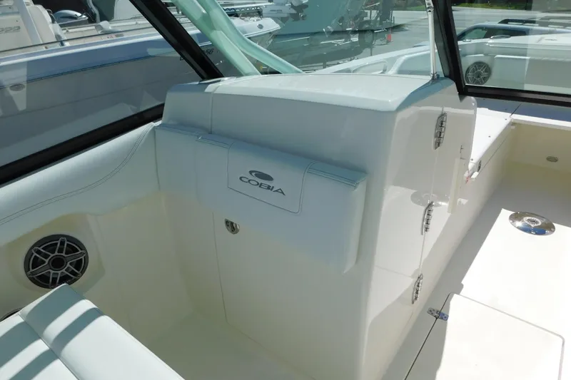 Slide: The Image of 2026 Cobia 240 Dual Console boat dashboard with steering wheel and controls. - 7