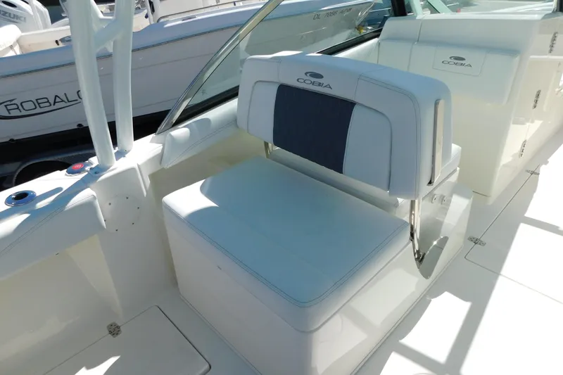 Slide: The Image of 2026 Cobia 240 Dual Console interior with seating and speaker detail. - 8