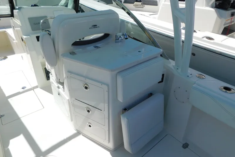 Slide: The Image of 2026 Cobia 240 Dual Console boat interior with cushioned seating and sleek design. - 9
