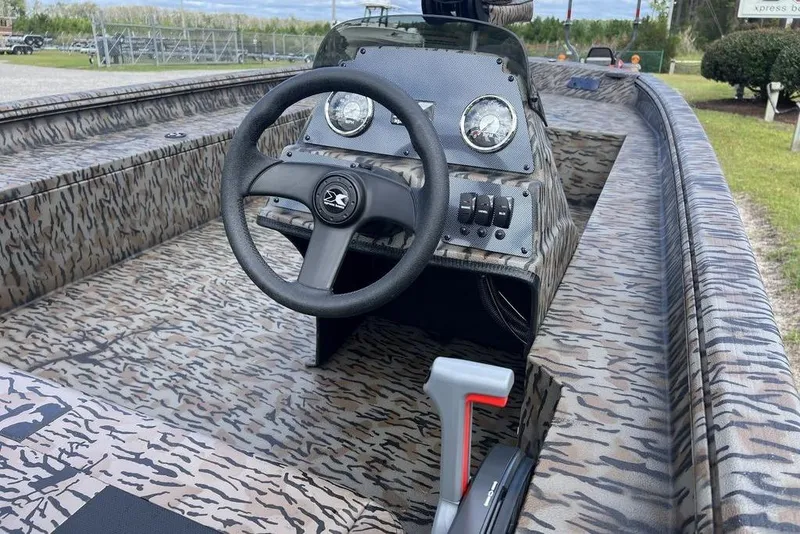 Slide: The Image of 2026 Xpress XP200 boat interior with camouflage design and steering wheel. - 12