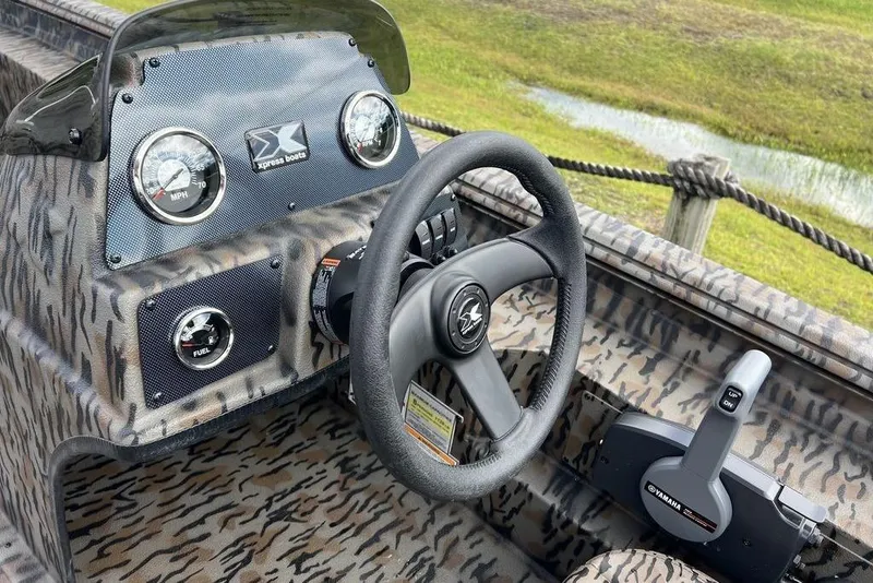 Slide: The Image of Steering console of 2026 Xpress XP200 boat with camouflage design and Yamaha controls. - 13