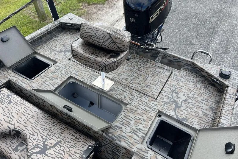 Slide: The Image of 2026 Xpress XP200 boat interior with camo design, featuring storage compartments and a swivel seat. - 14
