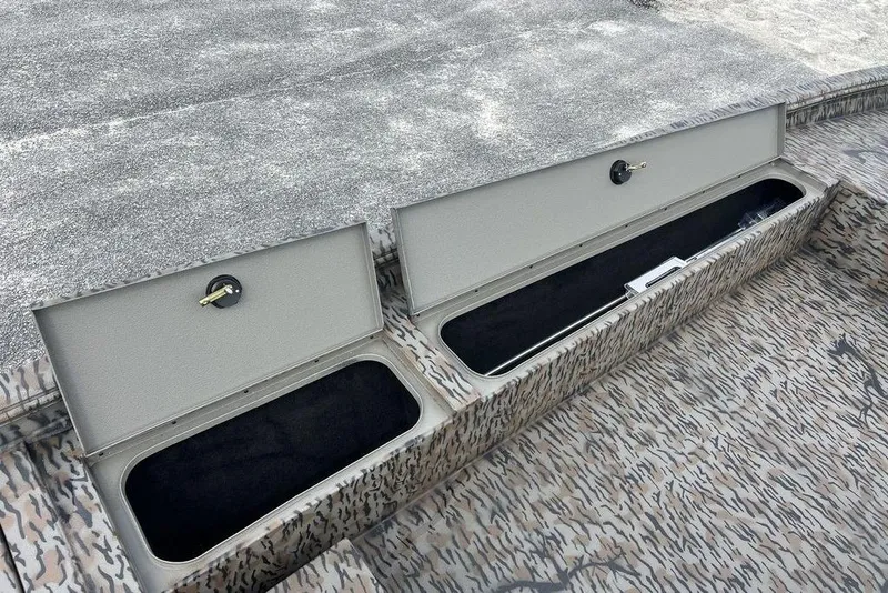 Slide: The Image of 2026 Xpress XP200 boat storage compartments with open lids, showcasing interior space. - 18